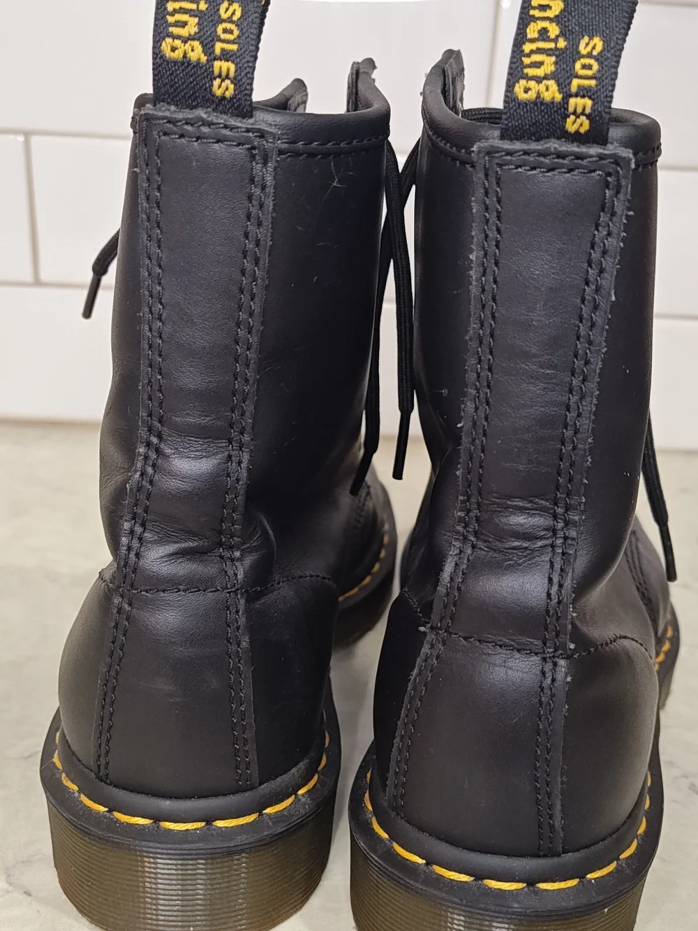 Dr. Martens Black Leather 8-Eye Lace-Up Boots with Yellow Welt Stitching